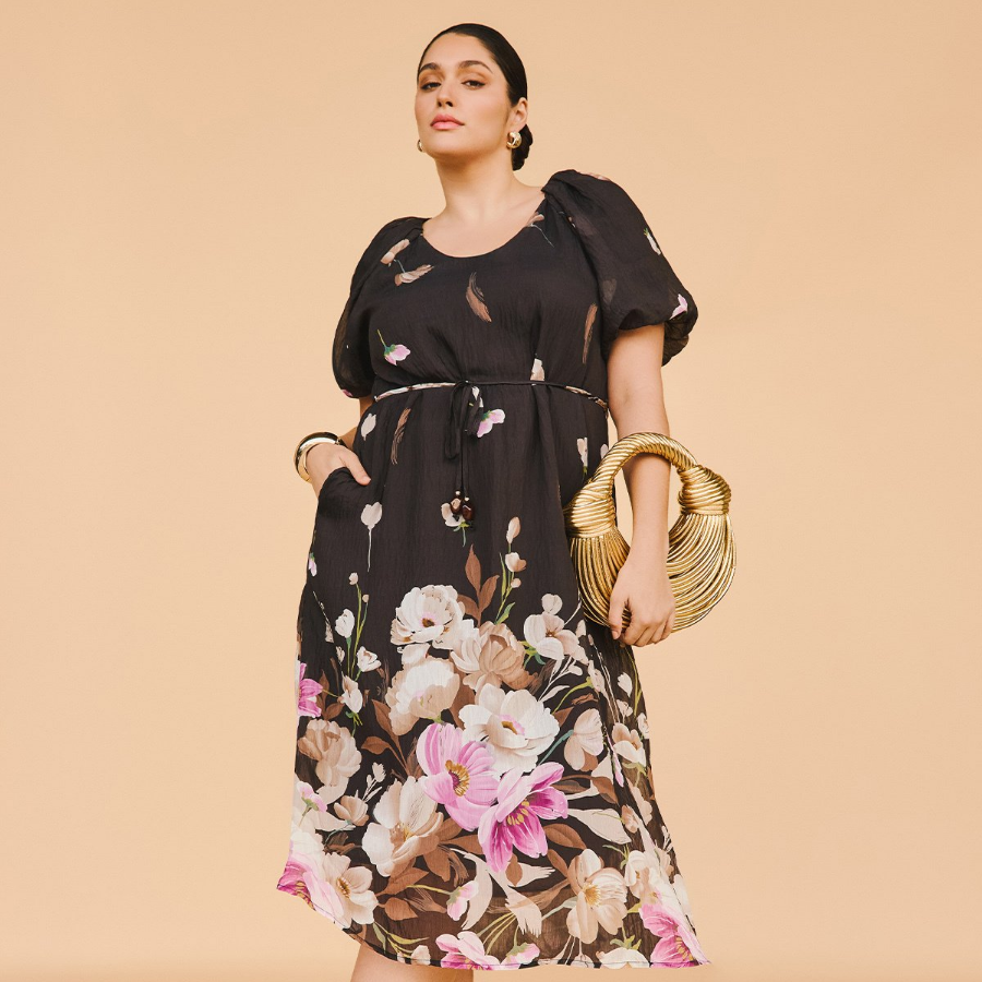 Lady wearing black floral dress with pink flowers from Taking Shape